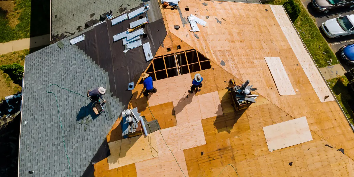 Couvreurs installant des tuiles neuves lors d'une réfection de toiture