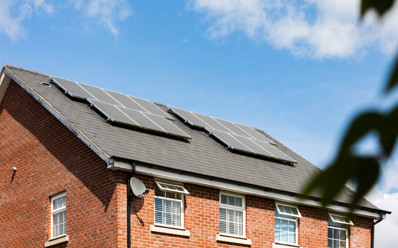 Maison en briques équipée de panneaux solaires sur le toit